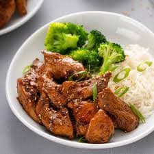 A plate of rice and chicken