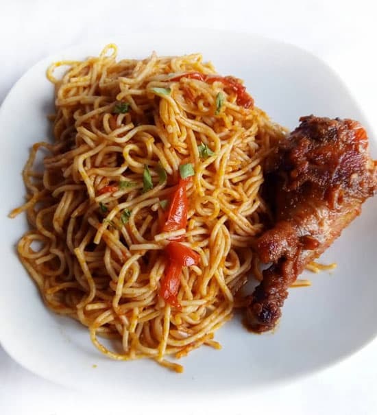 A plate of jollof spaghetti and chicken